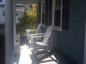 FRONT PORCH OF SMALL BLUE HOME